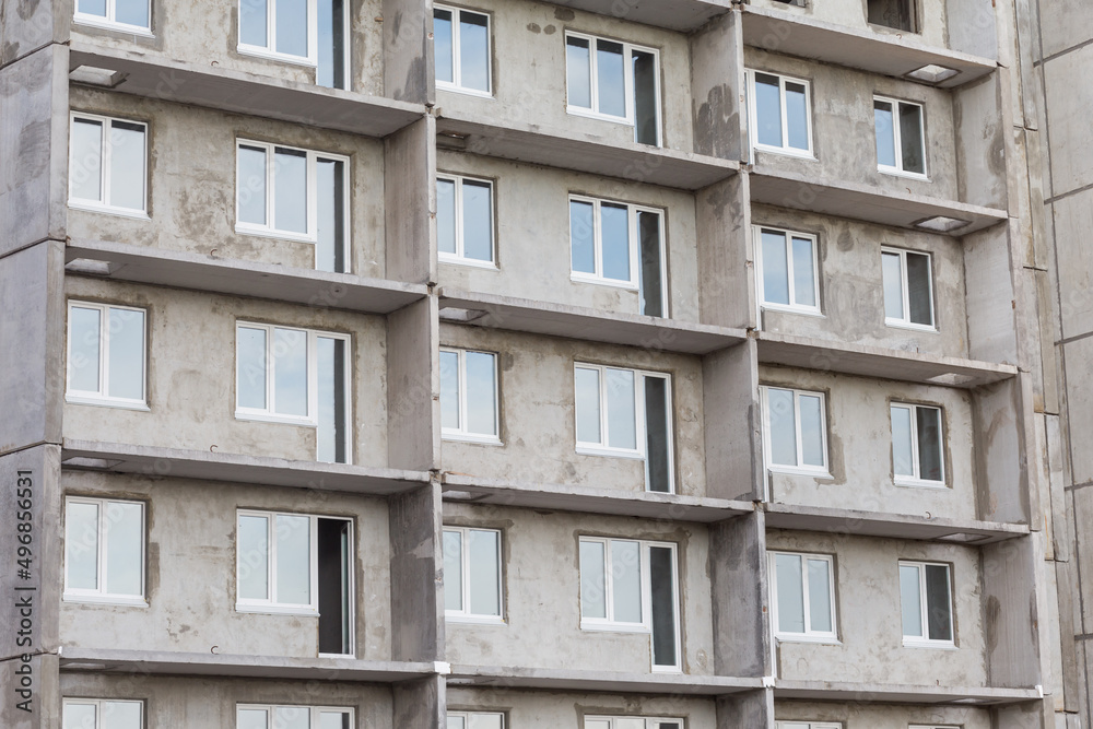 Facade of a modern building under construction. Multi-storey residential building under construction. Panel house. Construction concept. Close view. Facade of a modern building under construction. Multi-storey residential building under construction. Panel house. Construction concept. Close view.