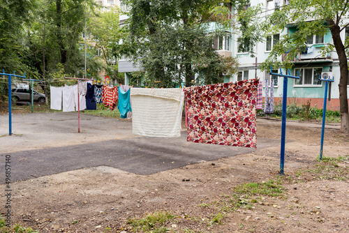 Laundry dries on the rope in courtyard of Khrushchyovka. Khrushchyovka is common type of old low-cost apartment building in Russia and post-Soviet space. Household concept. Russia, Vladivostok.