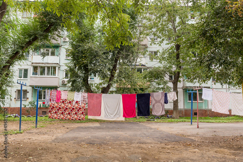 Laundry dries on the rope in courtyard of Khrushchyovka. Khrushchyovka is common type of old low-cost apartment building in Russia and post-Soviet space. Household concept. Russia, Vladivostok.