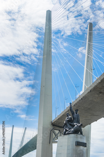 Russia, Vladivostok, June 05, 2021. View on Golden Bridge and monument to Merchant Navy from city downtown. Golden Bridge is the most famous sight of Vladivostok. Welcome to Vladivostok concept.