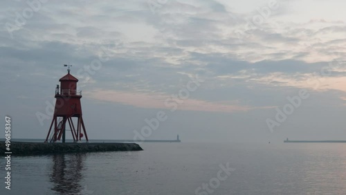 Herd Groyne Lighthouse. Old Victorian beacon in coastal harbor. photo