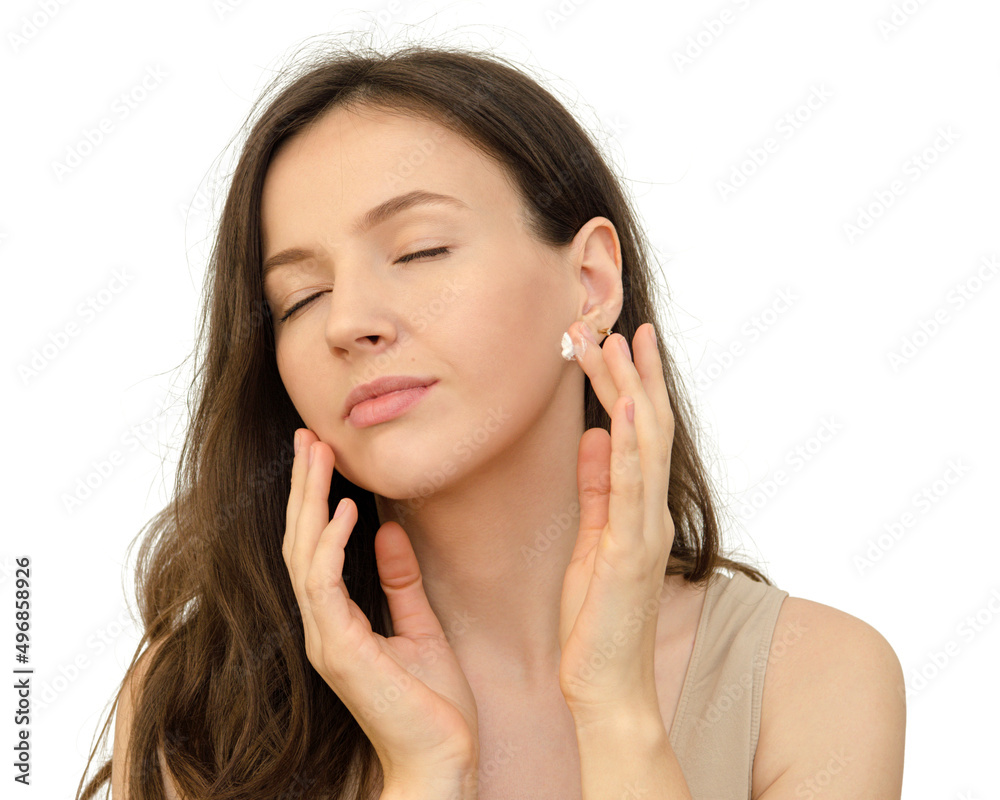 young beautiful woman brunette applying a face cream young beautiful woman brunette applying a face cream