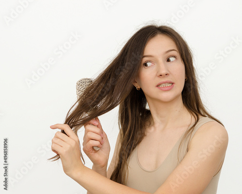 a woman is combing her hair