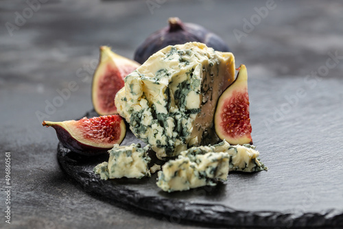 blue cheese and sweet fruit figs. blue cheese gorgonzola picante with blue mold from north of Italy. Food recipe background. Close up