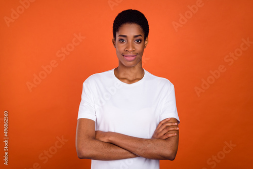 Photo of androgyne lady cross arms look in camera wear white t-shirt isolated vibrant color background