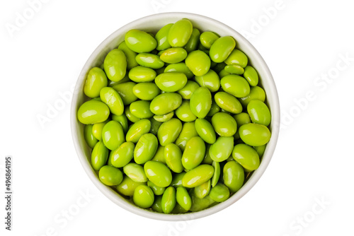 Soy beans edamame in a round bowl on a white background. Top view.