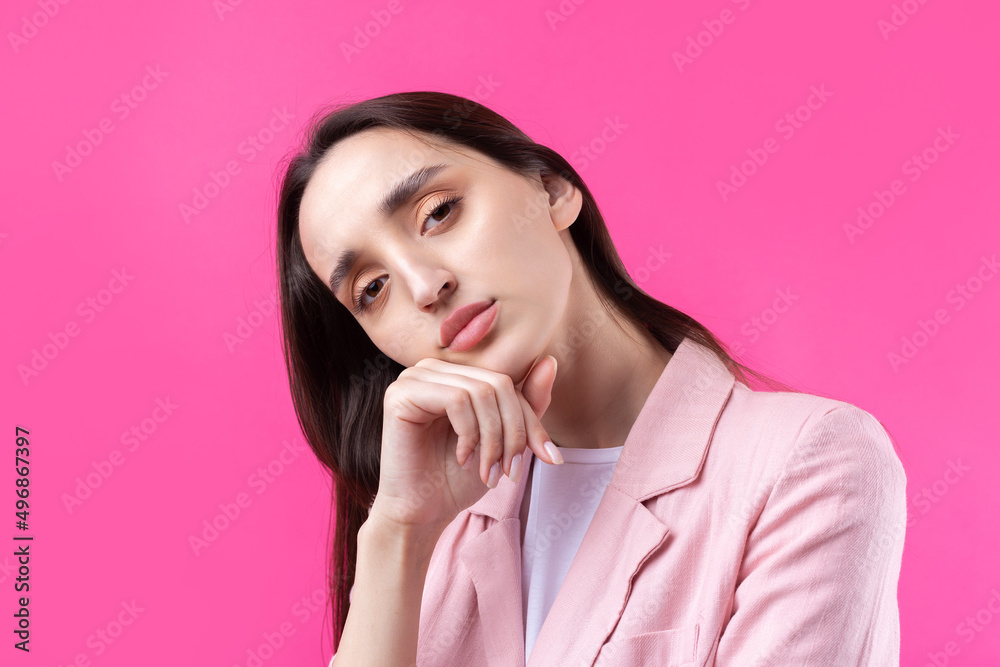 Portrait of beautiful young woman in pink jacket thinking isolated on red background Portrait of beautiful young woman in pink jacket thinking isolated on red background