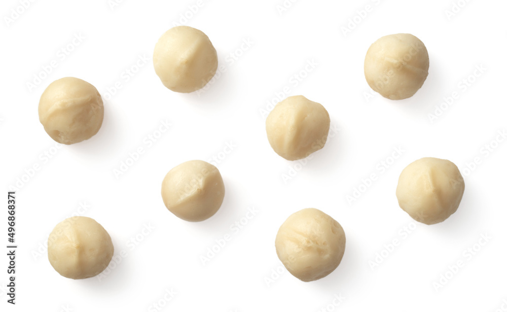 Unshelled macadamia nuts isolated on white background, top view. - obrazy, fototapety, plakaty 