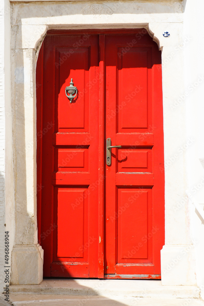the old and solid doors in painted wood are one of the charms of the Cyclades, in the heart of the Aegean Sea, here on the island of Tinos in the famous white village of the marble craftsmen of Pyrgos the old and solid doors in painted wood are one of the charms of the Cyclades, in the heart of the Aegean Sea, here on the island of Tinos in the famous white village of the marble craftsmen of Pyrgos
