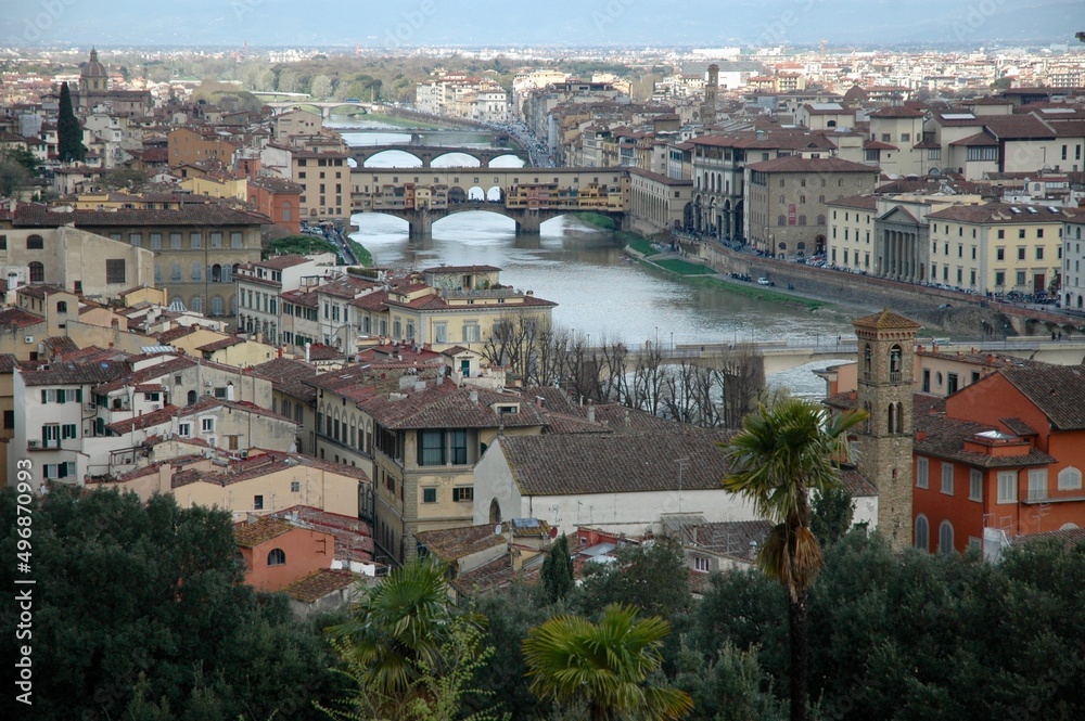The Arno river in the center of Florence with its bridges and the view of the historic center. 