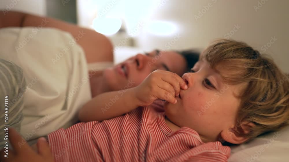 Mother telling bedtime story to little boy son Mother telling bedtime story to little boy son