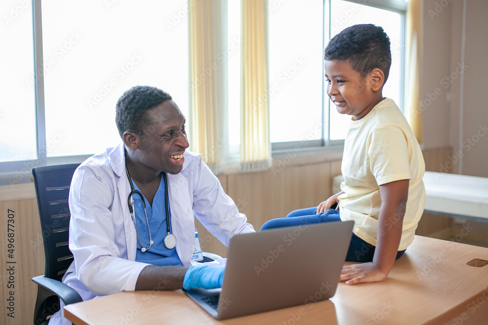 African pediatrician taking the patient's history and examining child boy patient. African pediatrician taking the patient's history and examining child boy patient.