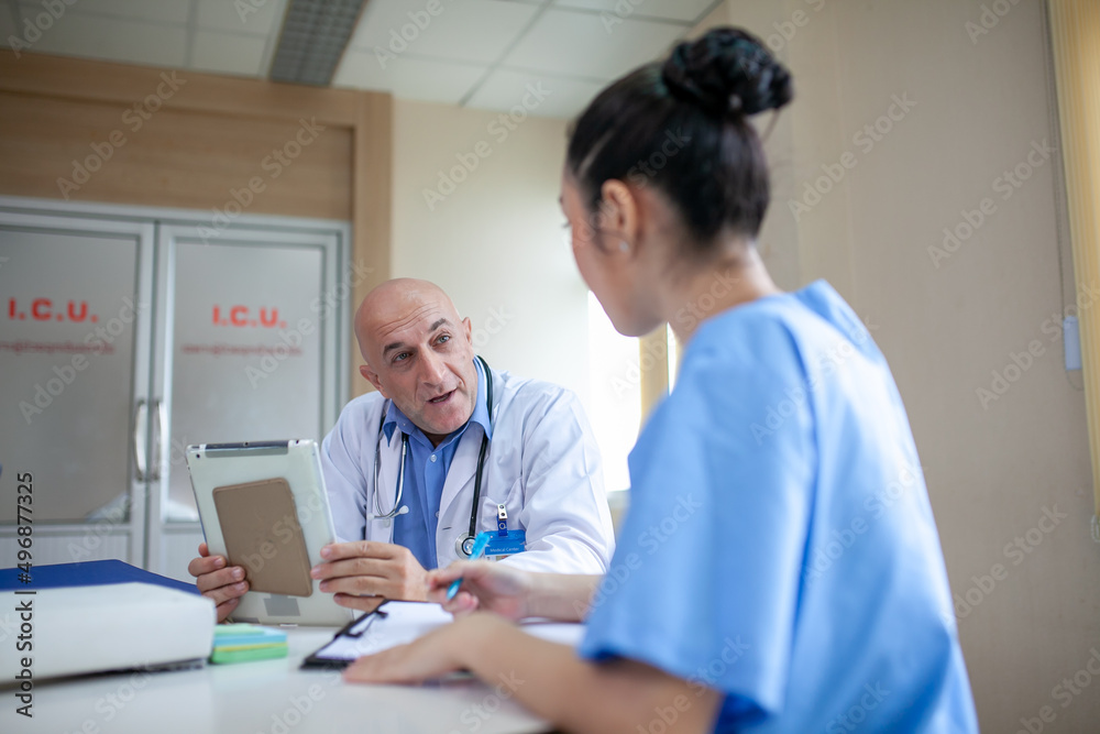 custom made wallpaper toronto digitalGroup of doctors consulting patient records, Elderly doctor and colleague discussing current disease therapy at working place.