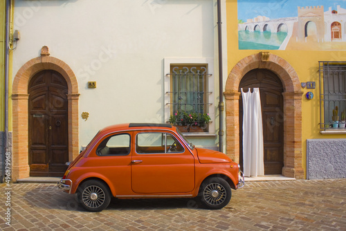 Red Fiat 500 D in San Giuliano district in Old Town of Rimini photo