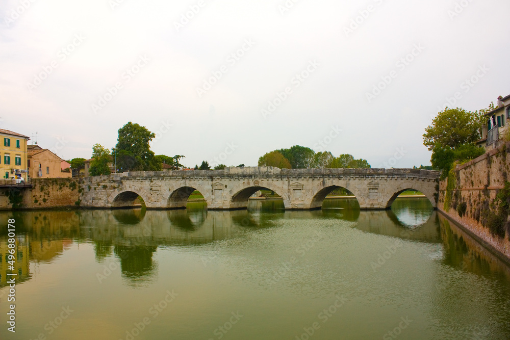 Historical roman Tiberius Bridge over Marecchia river in Rimini, Italy