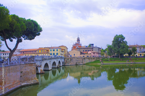 Historical roman Tiberius Bridge over Marecchia river in Rimini, Italy photo