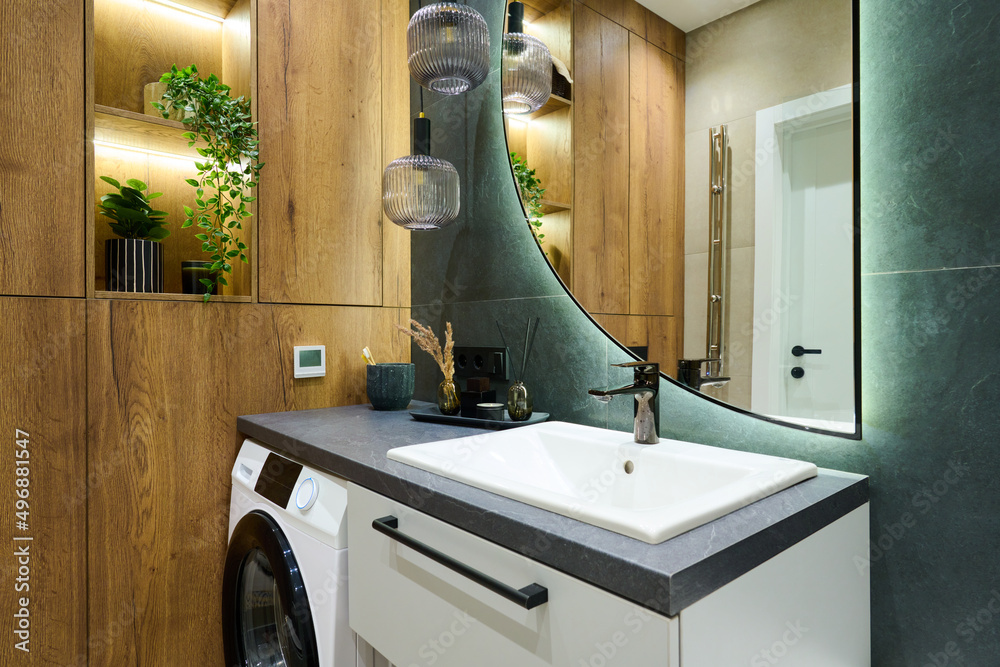 Part of bathroom with self care items, air freshener, washing machine