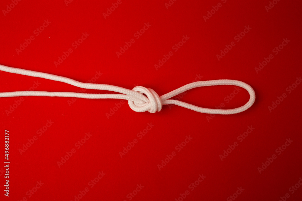 White shoe laces on a red background