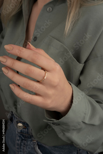 Young woman's hand wearing a diamond ring. wedding accessories bride.
