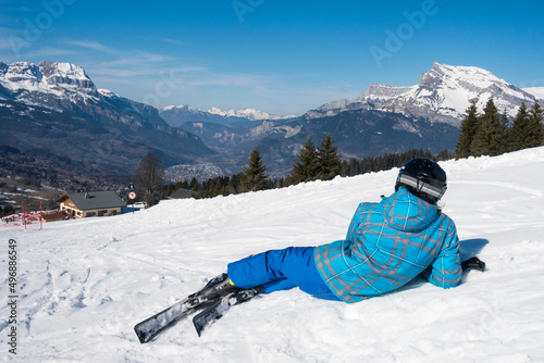 Skier sitting in the slope watching a beautiful landscape in Chamonix & Mont Blanc ski area