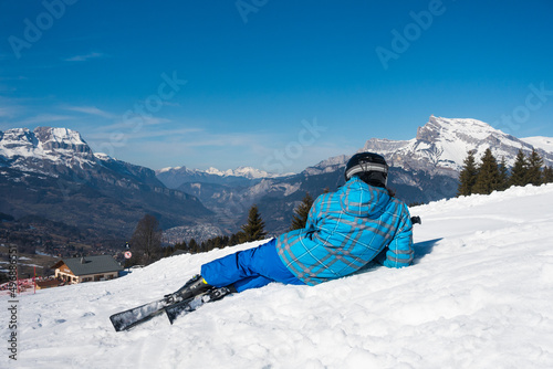 Skier sitting in the slope watching a beautiful landscape in Chamonix & Mont Blanc ski area