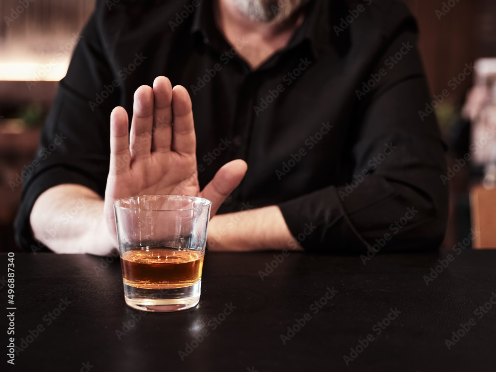 Man refuses or rejects to drink alcohol at the pub. Man refuses or rejects to drink alcohol at the pub.