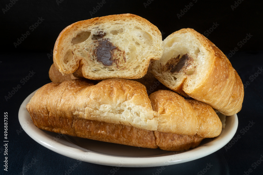 Croissants in a white plate on the table Croissants in a white plate on the table