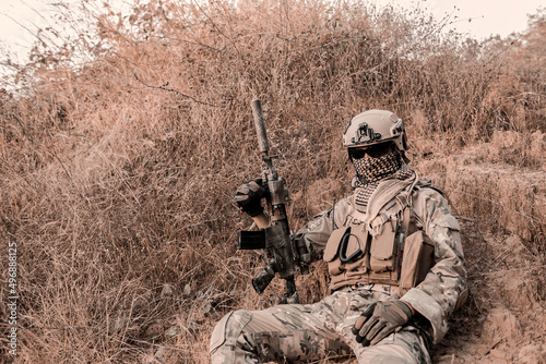 Slika na platnu Military camouflage to find opportunities to shoot enemies in the grass,soldier