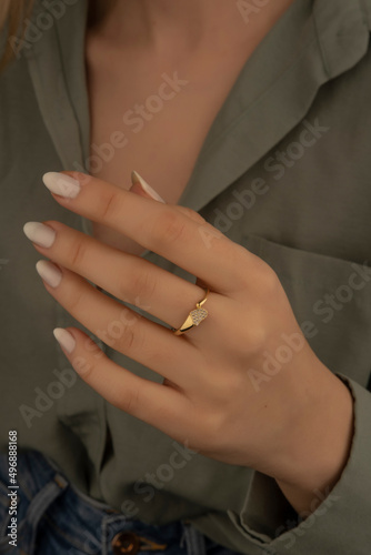 Young woman's hand wearing a diamond ring. wedding accessories bride. © Oguz