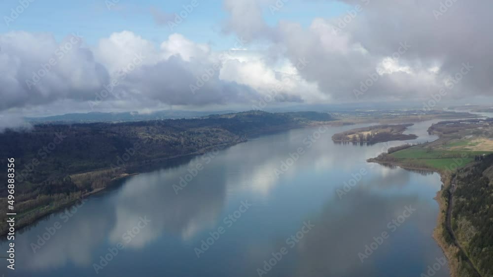 Low clouds drift over the Columbia River which runs between Oregon and Washington. The scenic Columbia River Gorge, with the Columbia River flowing through it, is over 80 miles long. Low clouds drift over the Columbia River which runs between Oregon and Washington. The scenic Columbia River Gorge, with the Columbia River flowing through it, is over 80 miles long.