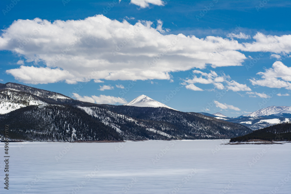 Colorado mountain views over frozen Dillon Lake Reservoir on a bright spring day near Frisco.
