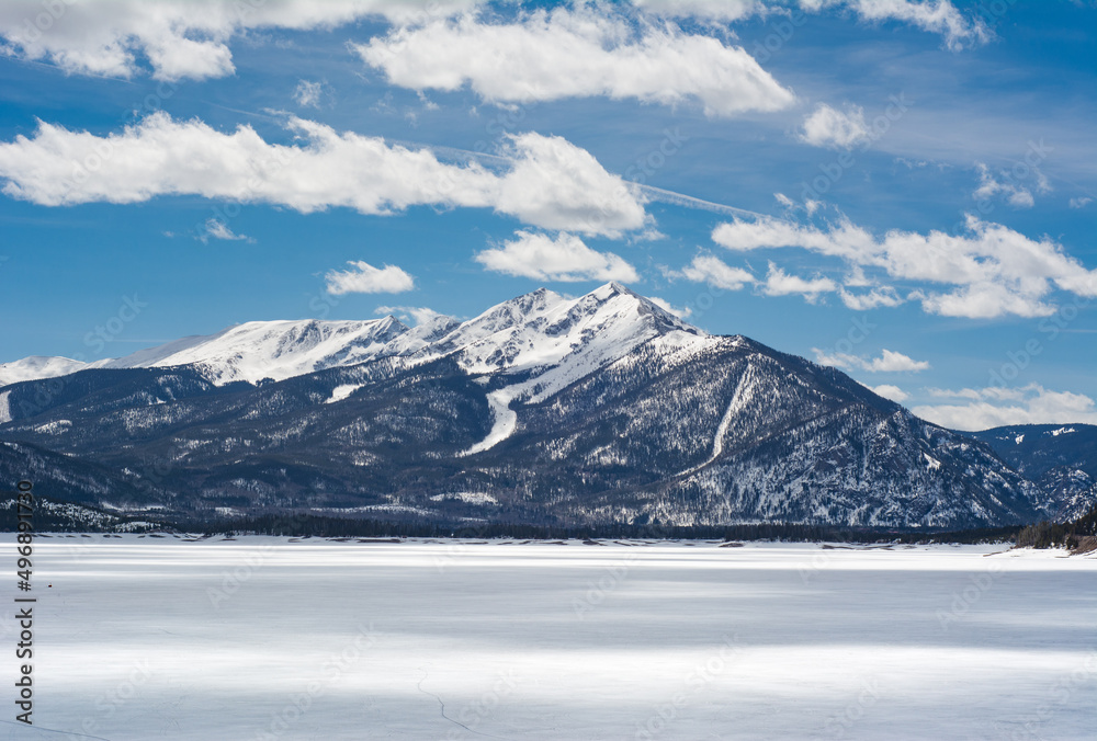Colorado mountain views over frozen Dillon Lake Reservoir on a bright spring day near Frisco.