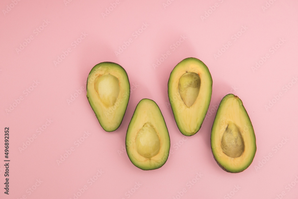 Avocado on a pink background Avocado on a pink background