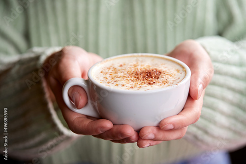 woman with cup of cappuccino