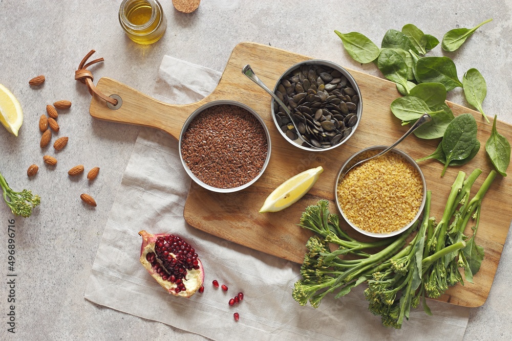 Plant based raw food vegan bulgur pumpkin seeds flax seeds fresh broccoli spinach. Nutrient rich balanced food concept. Plant based raw food vegan bulgur pumpkin seeds flax seeds fresh broccoli spinach. Nutrient rich balanced food concept.