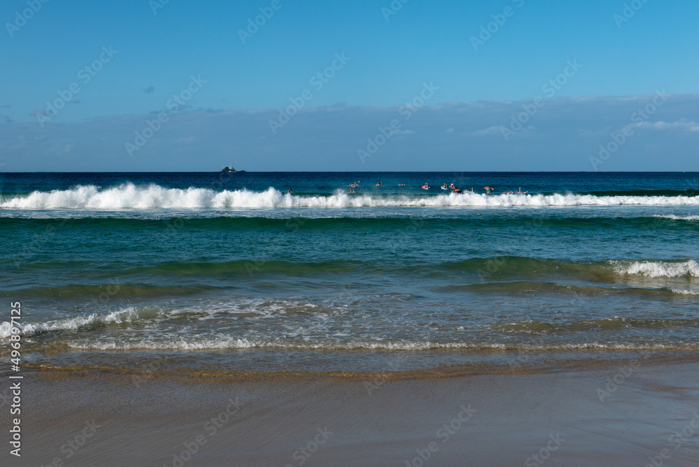 beach and waves with kids on boards