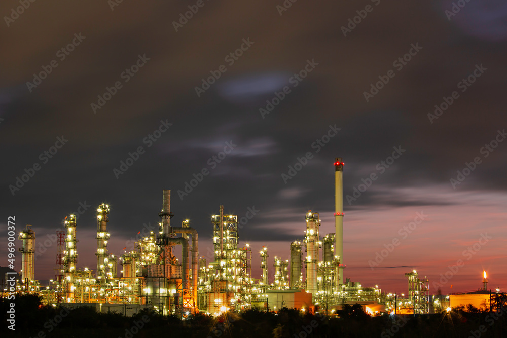 Oil​ refinery​ and​ plant and tower column of Petrochemistry industry in pipeline oil​ and​ gas​ ​industry with​ cloud​ slowing red sky