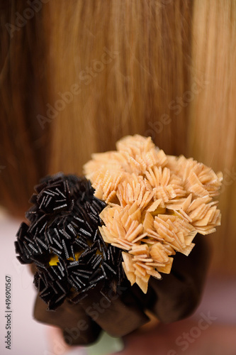 Selective focus ,hair extension equipment of natural hair. hair samples of different colors.Beautiful healthy shiny  Colors Palette. Hair Texture.