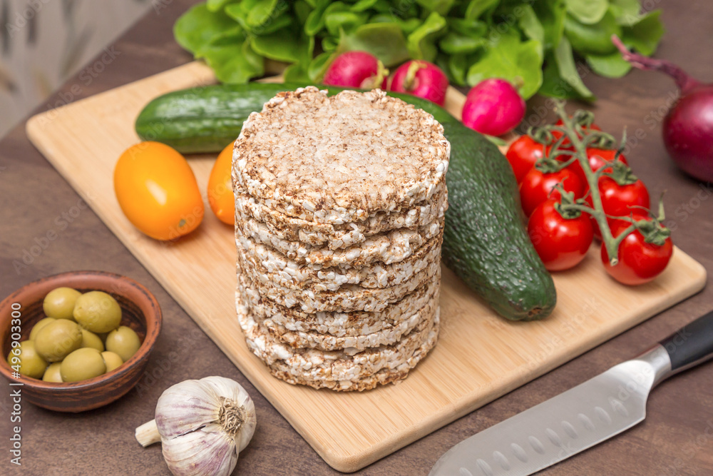Ingredients for cooking vegan vegetarian toasts with different vegetables and whole grain bread on kitchen table. Healthy diet food concept Ingredients for cooking vegan vegetarian toasts with different vegetables and whole grain bread on kitchen table. Healthy diet food concept