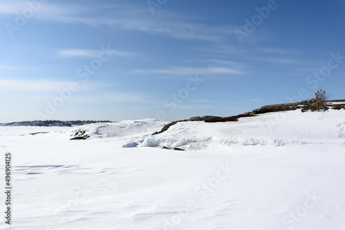 landscape with snow covered lake Ladoga under clear blue sky