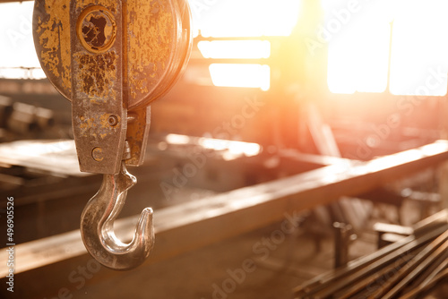 Industrial overhead beam crane lift background factory sunlight