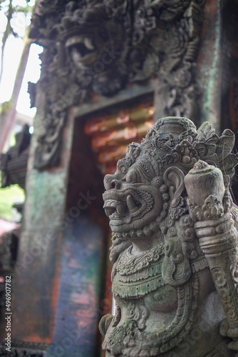 Traditional ancient stone statue at bali temple background in indonesia