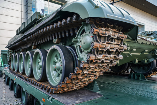Tank armoured vehicle loaded on truck, detail to continuous tread tracks