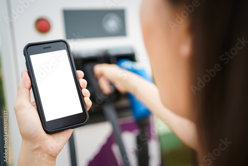 Empty screen of mockup smartphone isolated with clipping path. Asian young woman using ev charging application on smartphone.