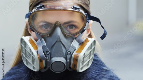 Young woman wearing full face respirator protective mask and goggles, extreme coronavirus protection concept photo