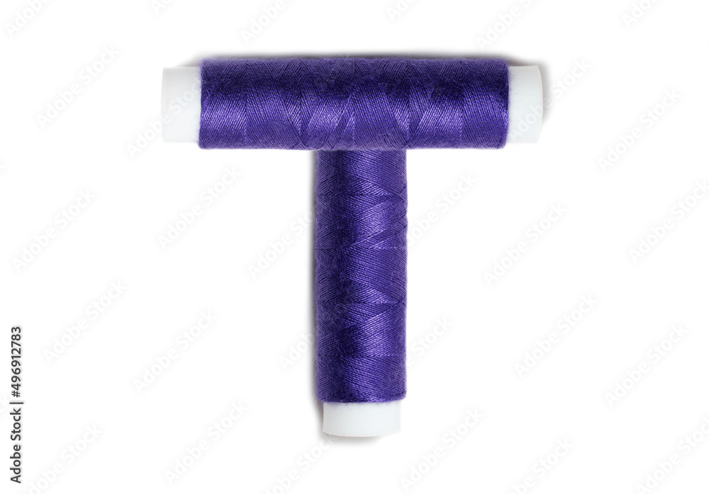 Letter of T from thread spools, isolated on white background. Alphabet concept. Letter of T from thread spools, isolated on white background. Alphabet concept.