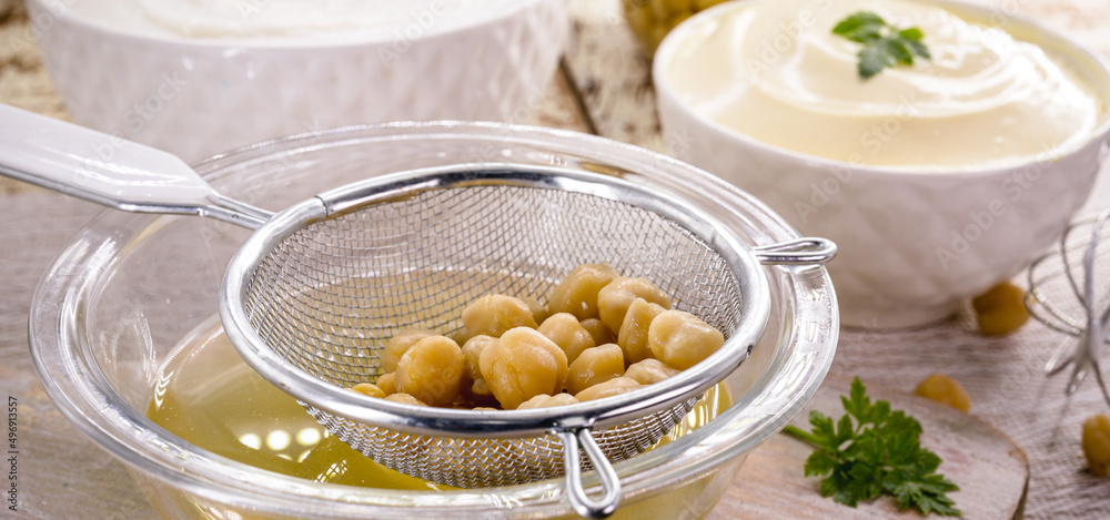 Aquafaba being prepared, cooking liquid from legumes such as chickpeas. It is an inexpensive substance, and alternative, substitute for egg whites in many sweet and savory recipes.