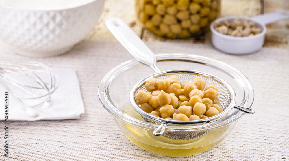 Aquafaba is the liquid for cooking chickpeas. Vegan or vegetarian ingredient used as a homemade alternative to egg whites in many recipes Aquafaba is the liquid for cooking chickpeas. Vegan or vegetarian ingredient used as a homemade alternative to egg whites in many recipes