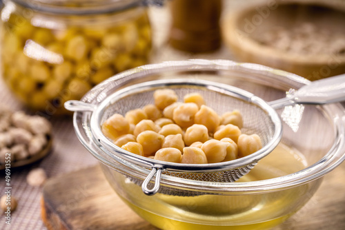 chickpeas being sieved to extract aquafaba, cooking liquid used as an alternative to egg whites photo