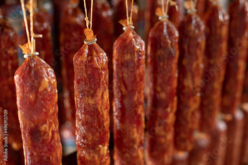 Factory for the production of meat products, cured sausages. Traditional spicy sausage hanging to dry, covered with fungus. Concept of handmade meat products. Delicacy.
